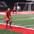 álvaro núñez — young defender controlling the ball on a floodlit stadium pitch