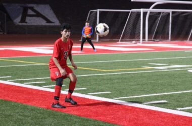 álvaro núñez — young defender controlling the ball on a floodlit stadium pitch