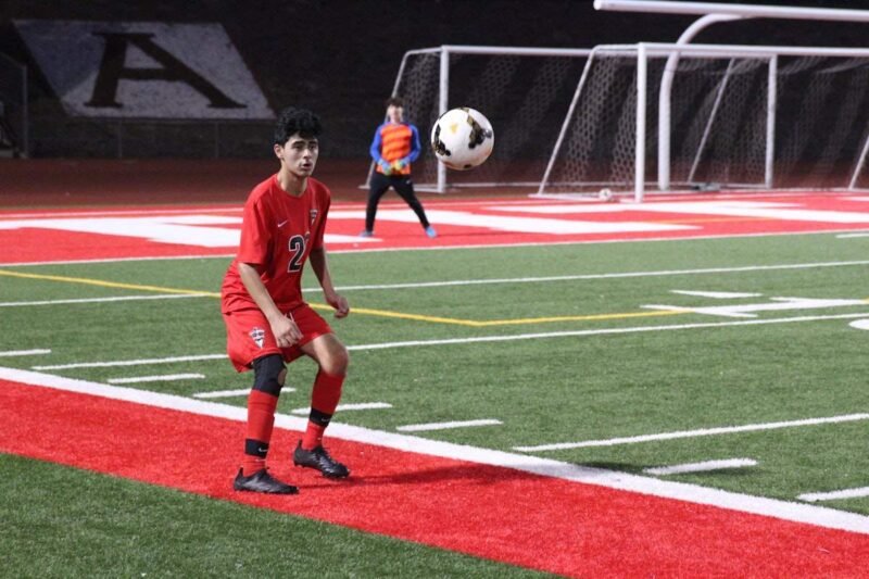 álvaro núñez — young defender controlling the ball on a floodlit stadium pitch