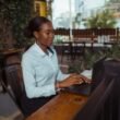 Person typing at a laptop while researching the meaning of fanquer online