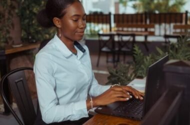 Person typing at a laptop while researching the meaning of fanquer online