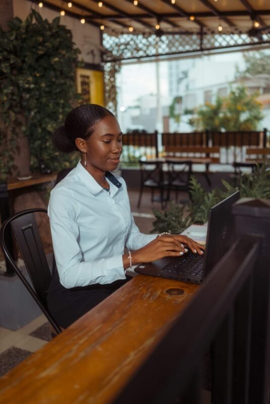 Person typing at a laptop while researching the meaning of fanquer online