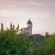 Shrek's girlfriend — a castle tower above the forest at dusk, like the one where Princess Fiona waited